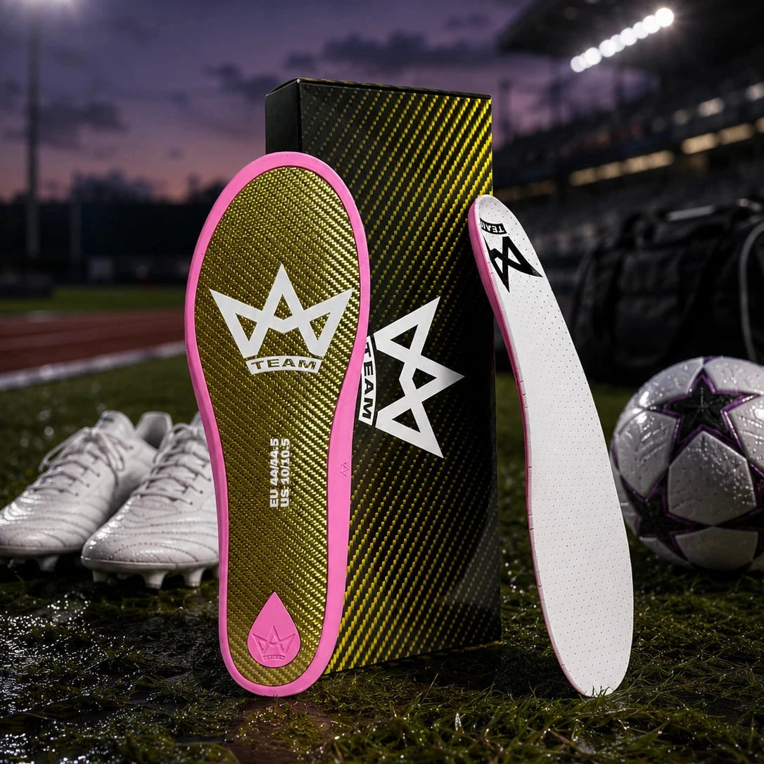 Performance insoles with pink trim and carbon fiber design, ideal for athletes on soccer field