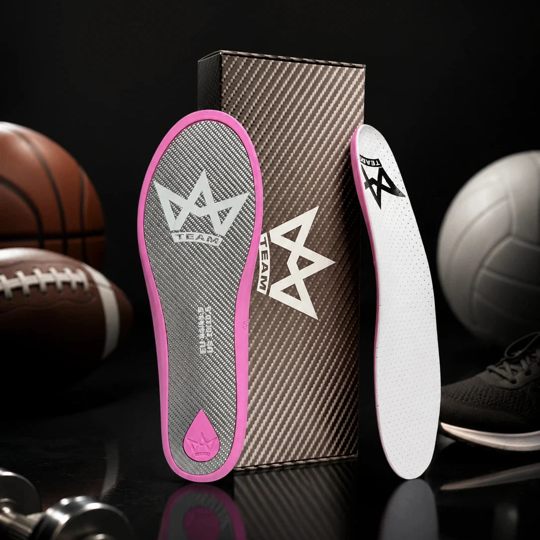 Pink and white performance insoles with crown logo, shown with sports balls and shoe, ideal for athletic comfort and support.