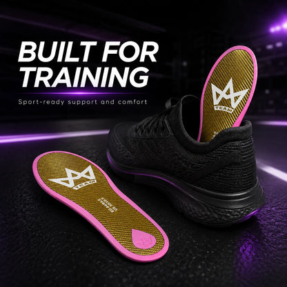 Performance insoles with pink trim and gold texture, designed for training support, shown beside black athletic shoe